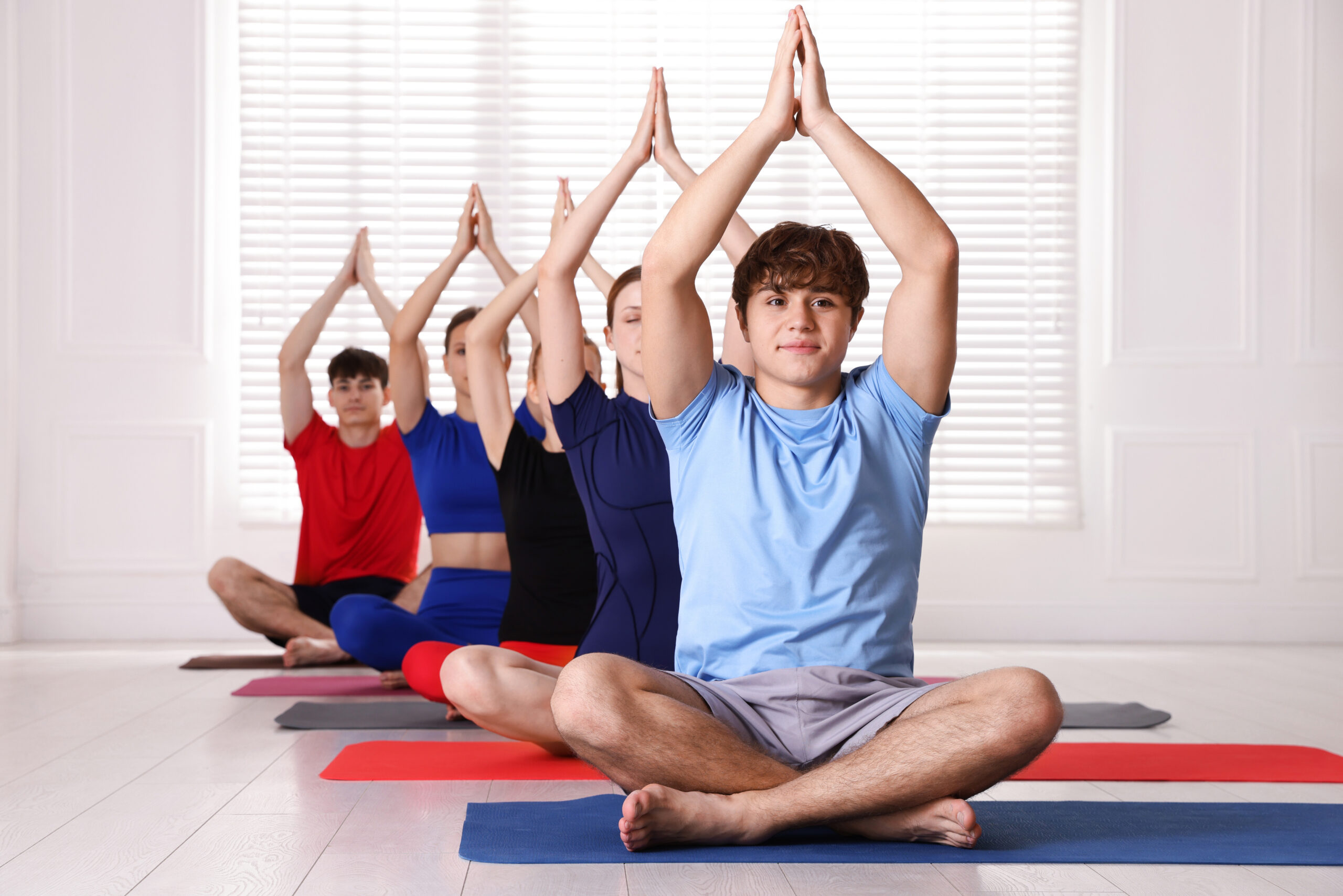 youth doing yoga class management program. 